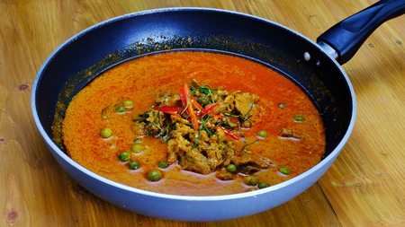 Ingredients for making famouse Thai  (panang) dish include, red and green chilli, holy basil leaves, kaffir lime leaves, and turkey berryの写真素材