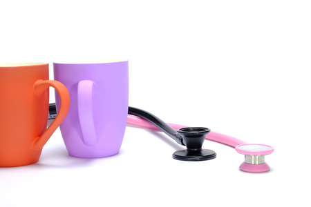 two coffee mugs and two stethoscopes on white backgroundの写真素材