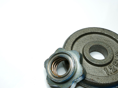 an iron cast weight plate and a weight plate holder, isolated, on white backgroundの写真素材