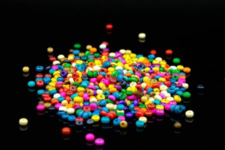 colorful wooden beads on black and mirrored image background の写真素材