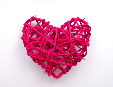 bright red woven heart shape rattan, isolated on white backgroundの写真素材