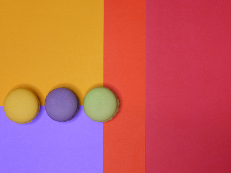 top view of colorful macaroons on bright color paper backgroundの写真素材