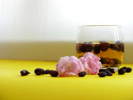 warm coffee cherries tea (or cascara in Spanish)  in a clear glass by the windowの写真素材