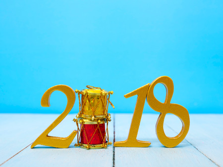 a golden new year 2018 banner on pale blue wooden backgroundの写真素材