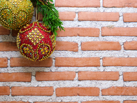 red and gold Christmas balls with glittering golden beads and glasses, on bricks and mortar backgroundの写真素材