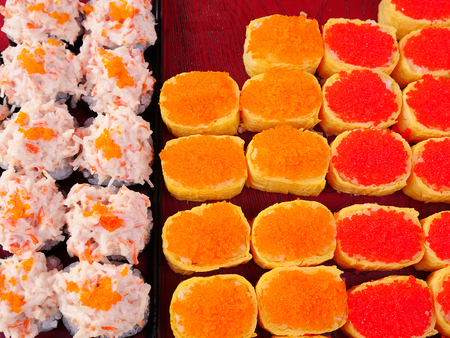 Colorful and delicious sushi, once a restaurant delicacy, is now sold at low price throughout street markets in Thailand.の写真素材
