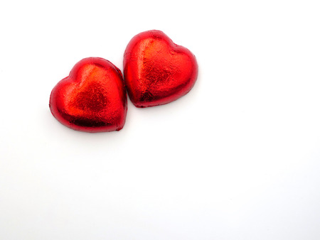 red heart-shaped chocolate candies  closeup, isolated on white background,  Valentines' Day, romantic concept, top viewの写真素材