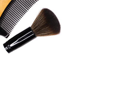 a comb made from natural cherry wood and a beauty brush, isolated on white background, wooden object, top viewの写真素材