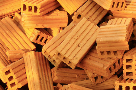 a pile of orange bricks on the construction site