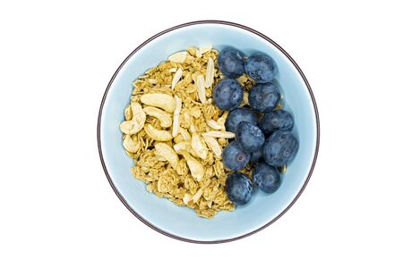 A bowl of fresh blueberries muesli with almond slices and cashew nuts. Closeup. Top view.の写真素材