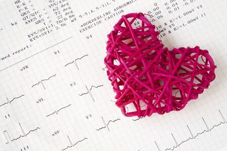 A red ratten heart and a normal electrocardiogram. Healthy heart concept.の写真素材