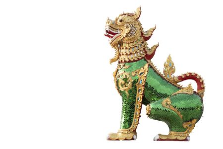 Mythical animal statue decorated with green glass and gold paint.の写真素材