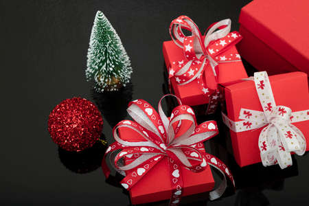 Gift boxes and Christmas decorations on a reflective background.の写真素材