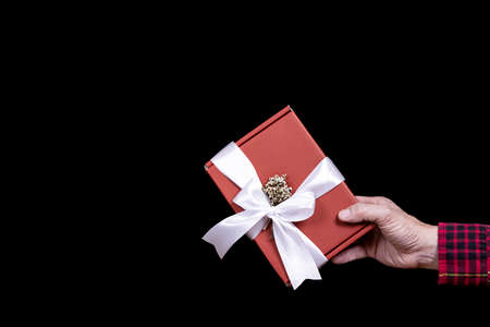 A man giving a red gift box.