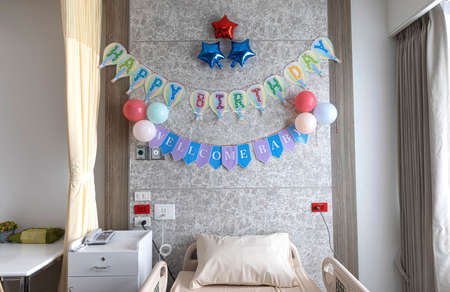A greeting message over the bed in a maternity ward. A happy birthday note fo a newborn baby concept.の写真素材