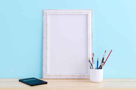 3d rendered illustration of a mockup picture frame on a wooden desk.の写真素材