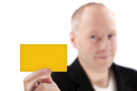 A businessman offering orange business card