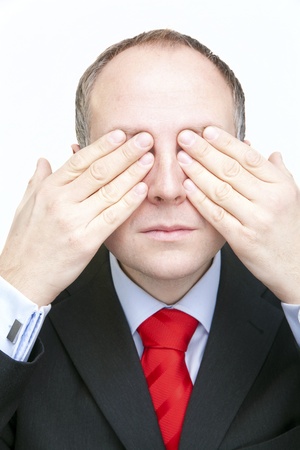 Businessman covering his eyesの写真素材