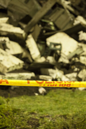 House lies in rubble behind police tape の写真素材