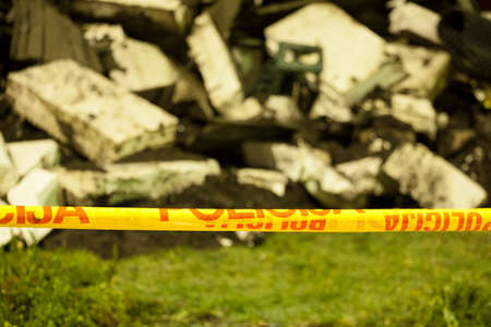 House lies in rubble behind police tape の写真素材