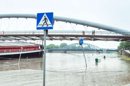 Flood  Sidewalk covered with water from the river in Krakow, Poland のeditorial素材