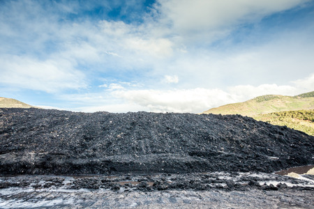 Coal pile in the mountainous mine and blue skyの写真素材