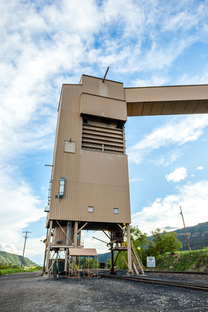 Coal mine infrastructure among beautiful mountains and green grass of USA