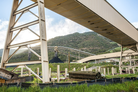 Coal mine infrastructure among beautiful mountains and green grass of USA