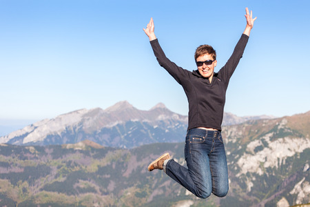 Happy jumping tourist in a high Tatra mountains