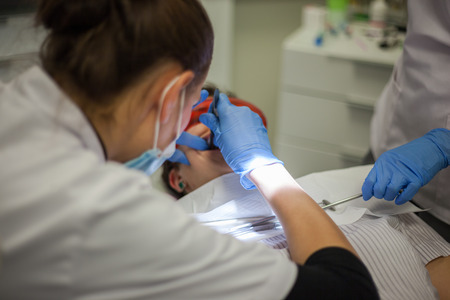 Patient in dentist office - cleaning teeth and putting braces