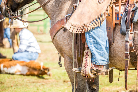 Cowboy riding on a brown horse .の写真素材