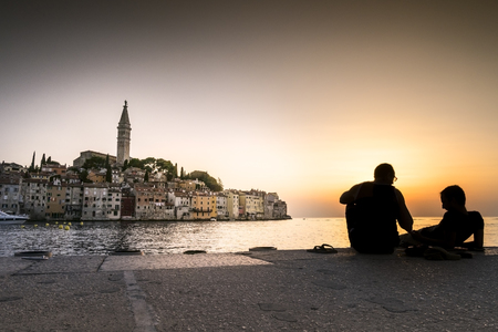 Beautiful historic Rovinj with people on pier, Croatia, Europeの写真素材