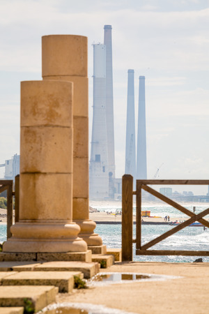 Ruins of ancient Cesarea and power plant chimneys, Israelの写真素材