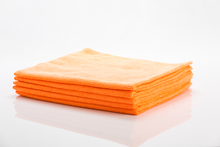 Orange cleaning clothes isolated on white backgroundの写真素材