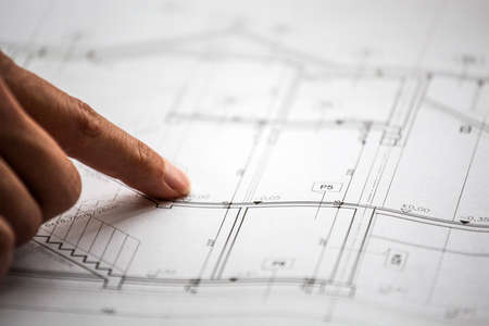 Pointing to specific place on architectural sketches of new house
