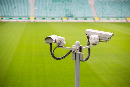 Surveillance cameras controlling sport pitch with green swardの写真素材