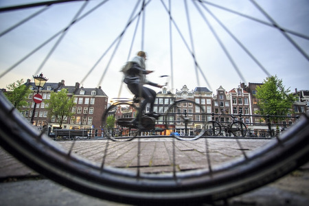 Riding a bicycle in Amsterdam, The Netherlands, Europeの写真素材
