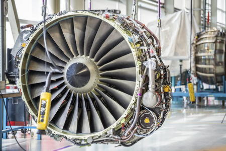 An airplane engine during maintenance in a warehouseの写真素材