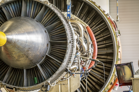 An airplane engine during maintenance in a warehouseの写真素材
