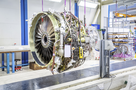 An airplane engine during maintenance in a warehouse