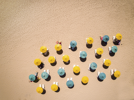Relax on the beach - sunbeds and umbrellas on hot sandの写真素材