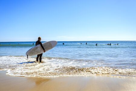 Surfers on Beliche Beach, Mediterranean Sea, Portugalの写真素材