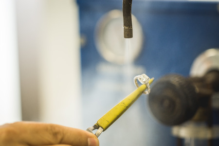 Cleaning of precious diamond ring in jewellery workshopの写真素材