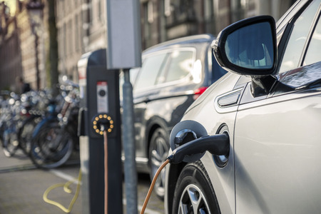 Charging an electric car in public station by the street, The Netherlands