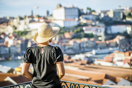 Young woman in summer hat enjoying sunny southern city, Porto, Portugalの写真素材