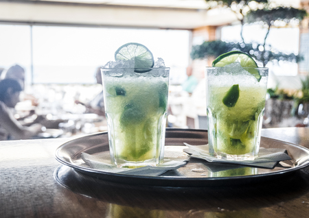 Two caipirinha cocktails on a bar counter in the restaurant