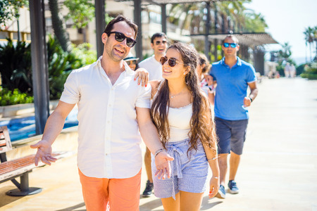 Pretty girl and handsome boy hanging out with friends in the city