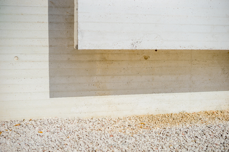 Abstract modern concret architectural detail with white gravel