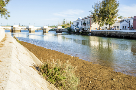 Historic roman bridge over Gilao river in Tavira, Algarve, Portugalの写真素材