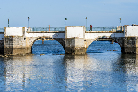 Historic roman bridge over Gilao river in Tavira, Algarve, Portugalの写真素材